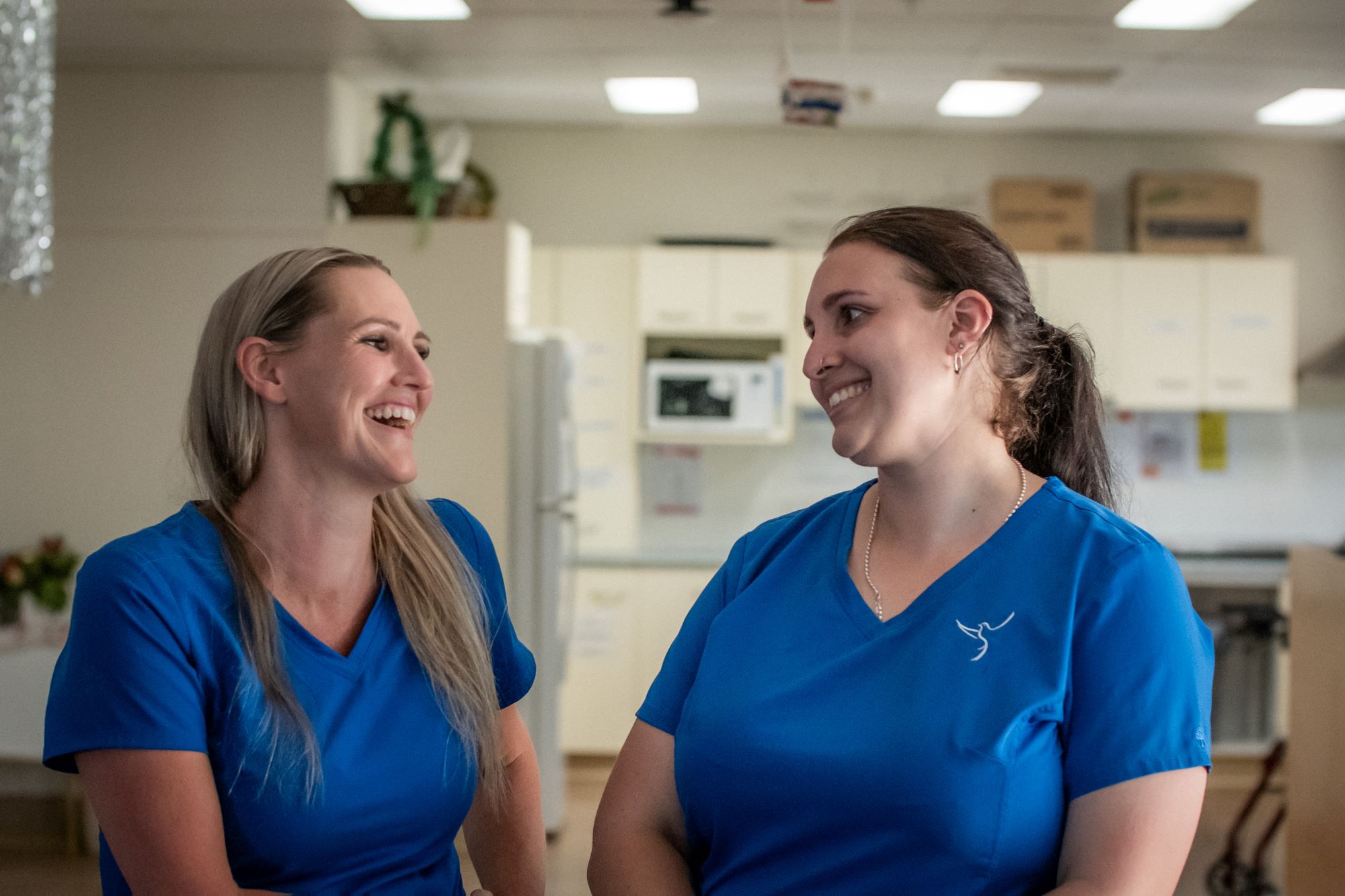 Catholic Health Care employees smiling at each other