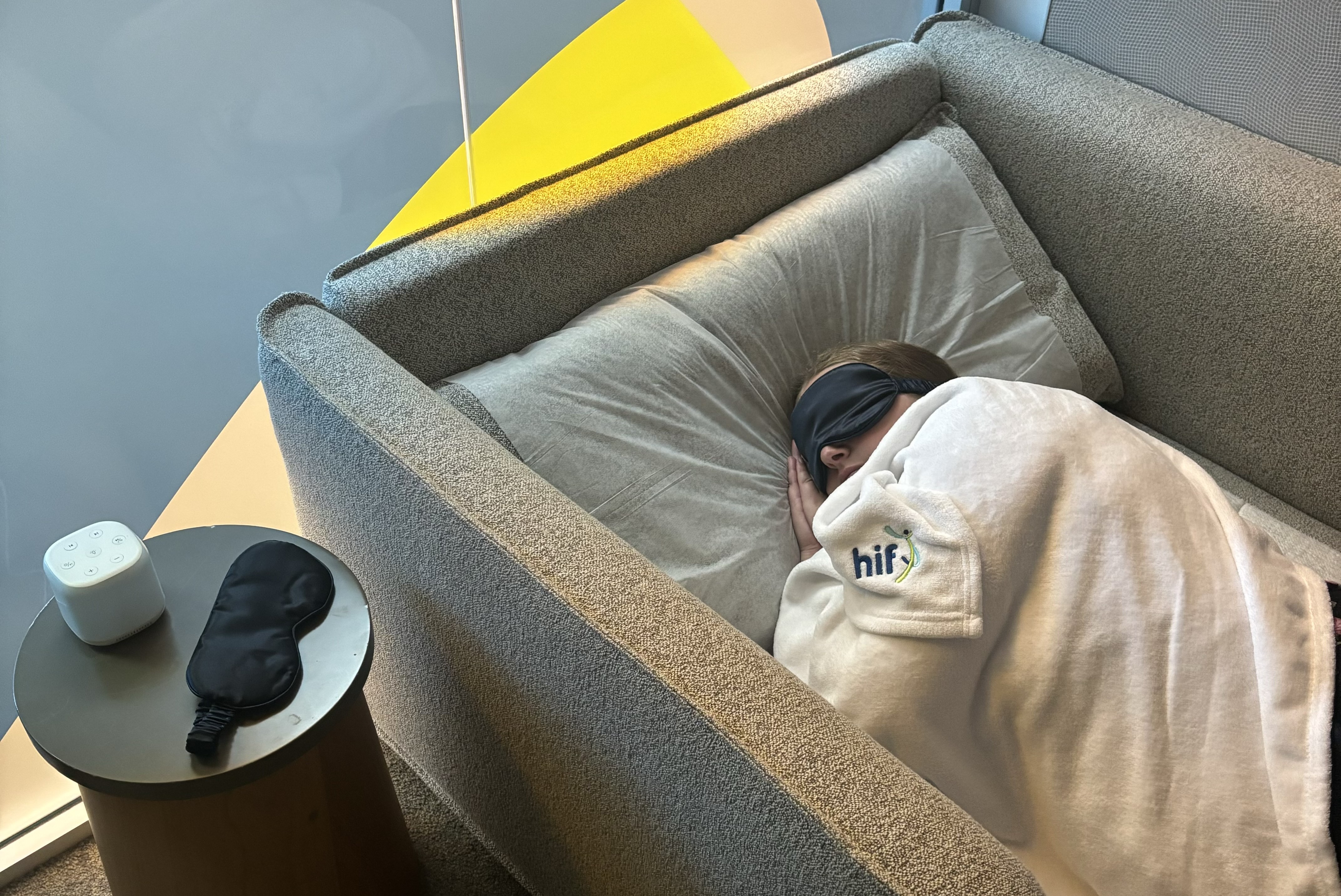 HIF employee sleeping in nap room with HIF blanket over them