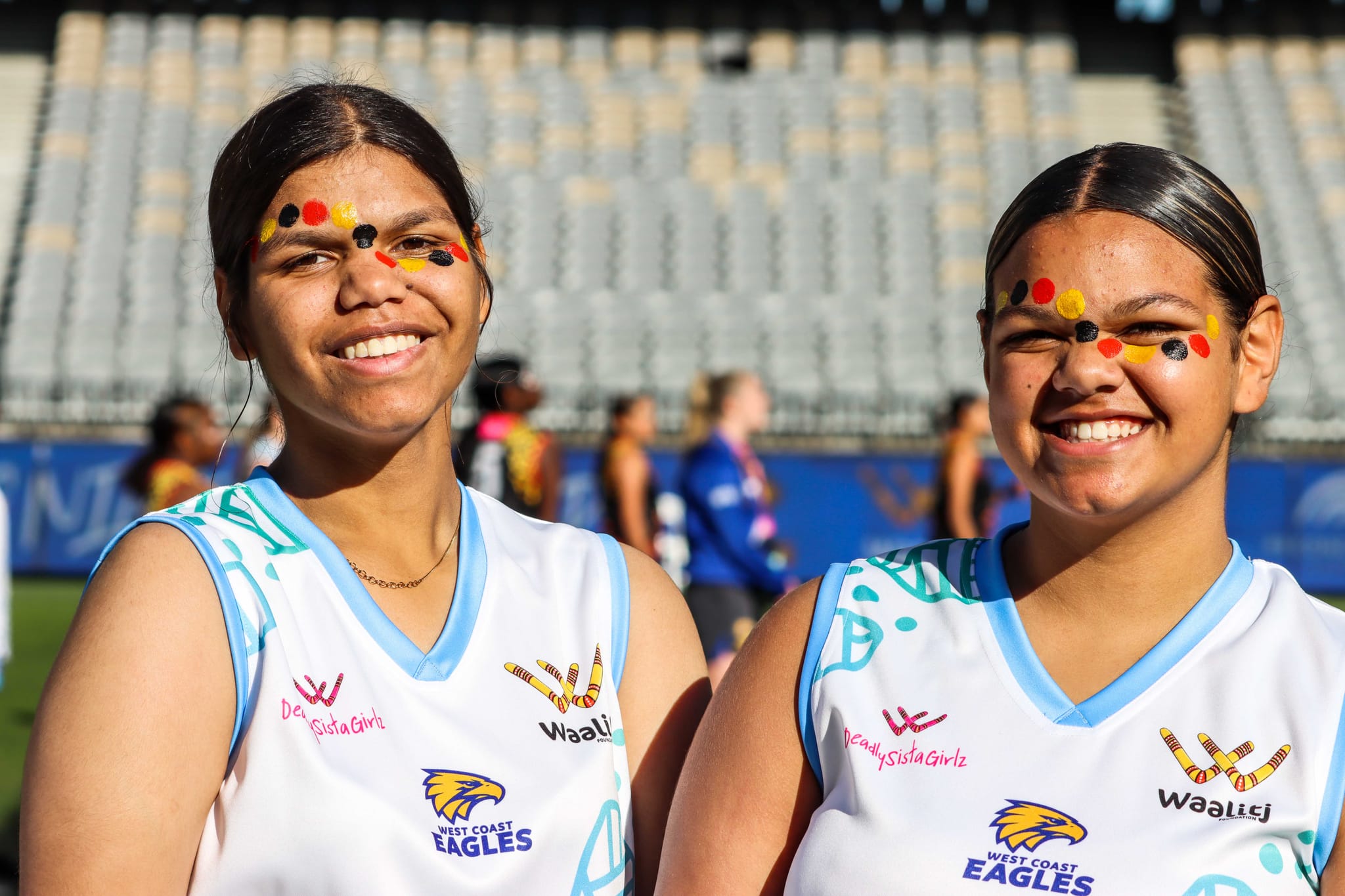 Two girls in jerseys from the Waakutj Foundation
