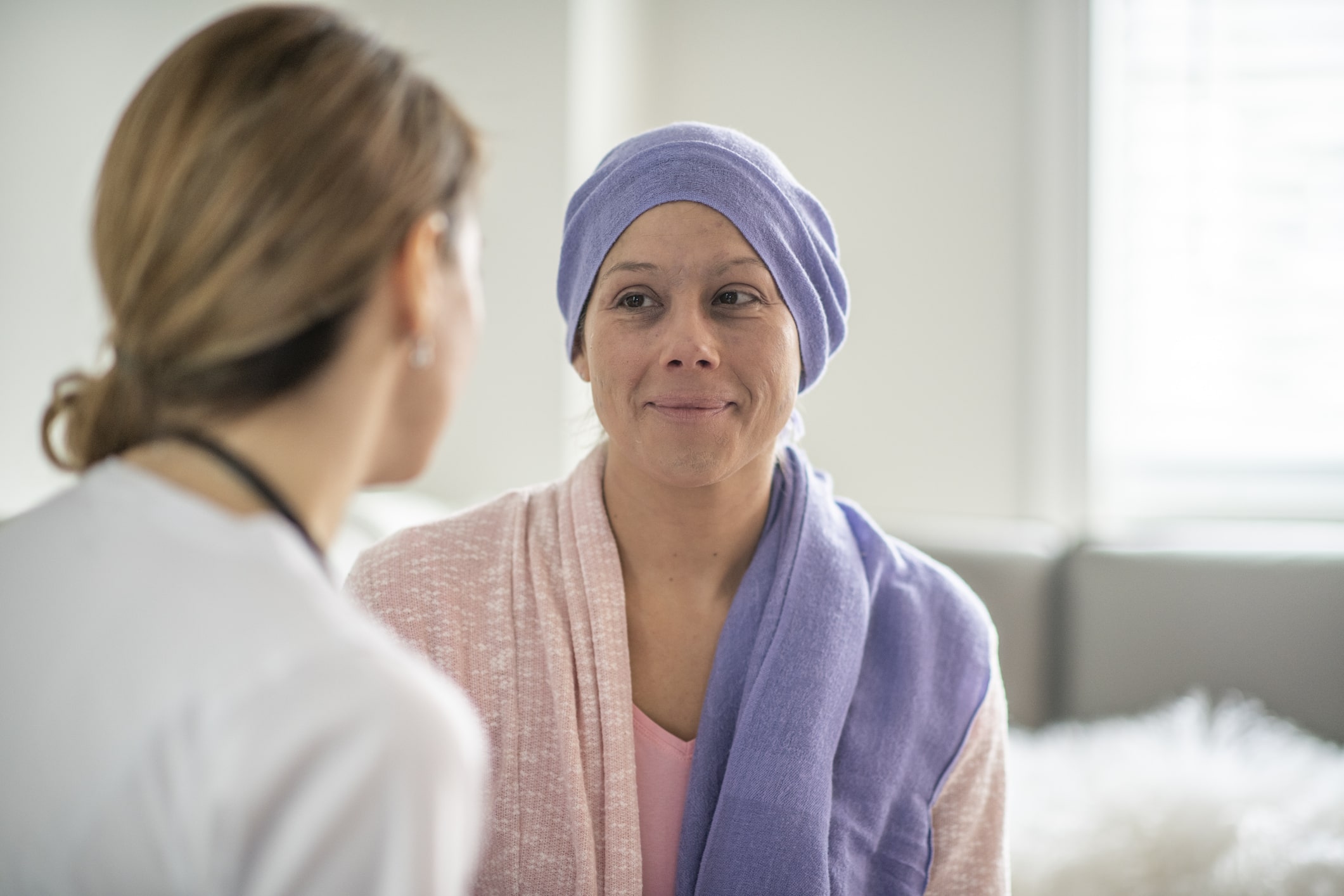 woman-with-purple-headscarf-talking-to-nurse